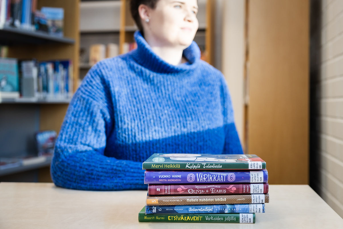 Lukutaitovalmentaja katselemassa ikkunasta ulos.